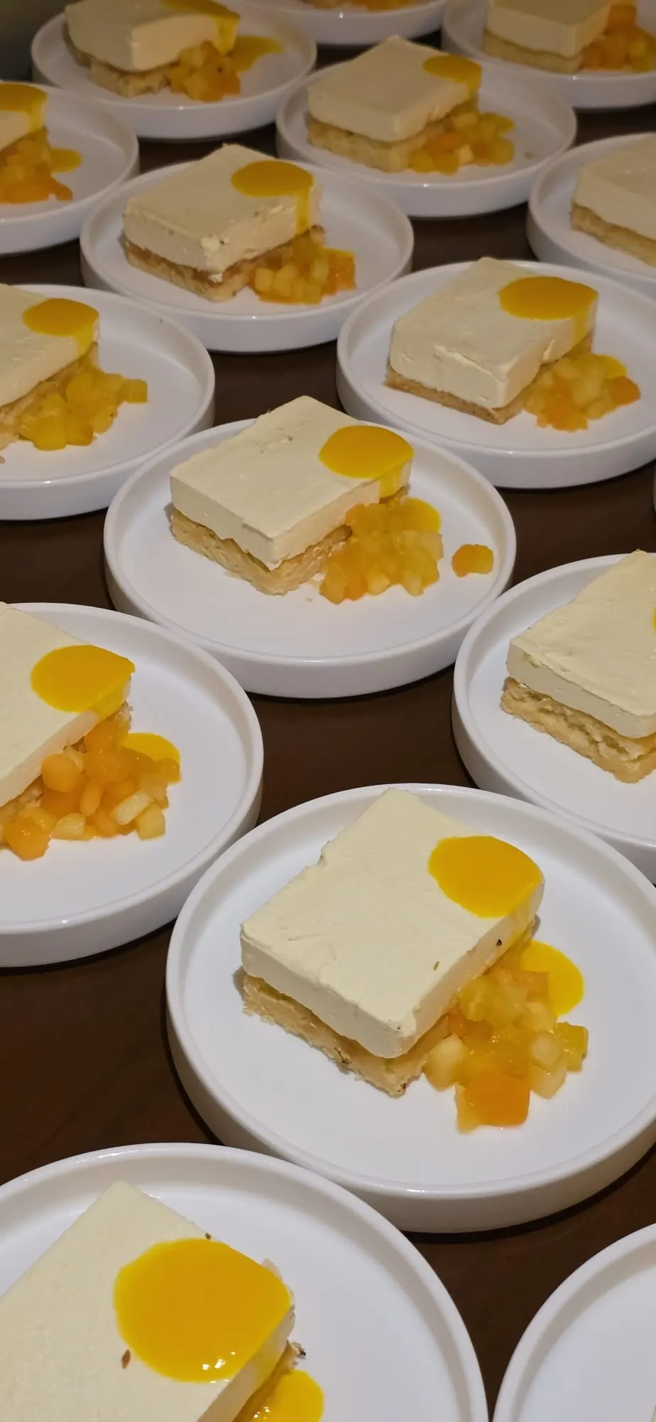 Plated desserts with mango sauce and diced tropical fruit